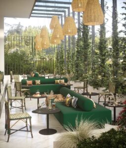 large bench for outdoor seating with additional French Bistro chairs