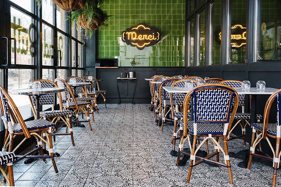 various tables with french bistro chairs in a french restaurant